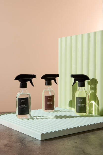 Three Room Sprays in  PET bottles. 
 One with a green label that reads " Sicilian Lime & Bergamot " scented, Black label reads "Rose & Sandalwood"  and another with a brown label that reads " Saffron & Patchouli " scented. 